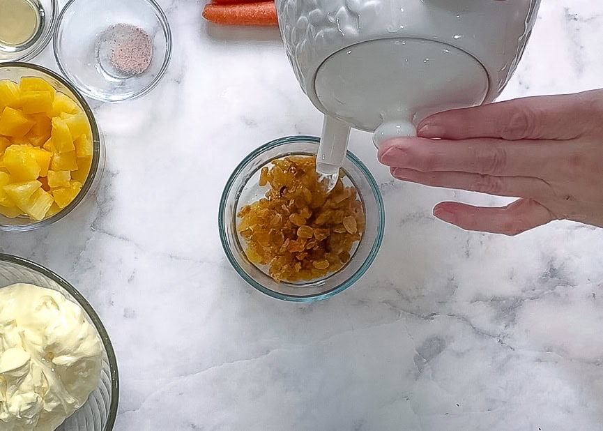 Pour hot water over raisins to plumb them up