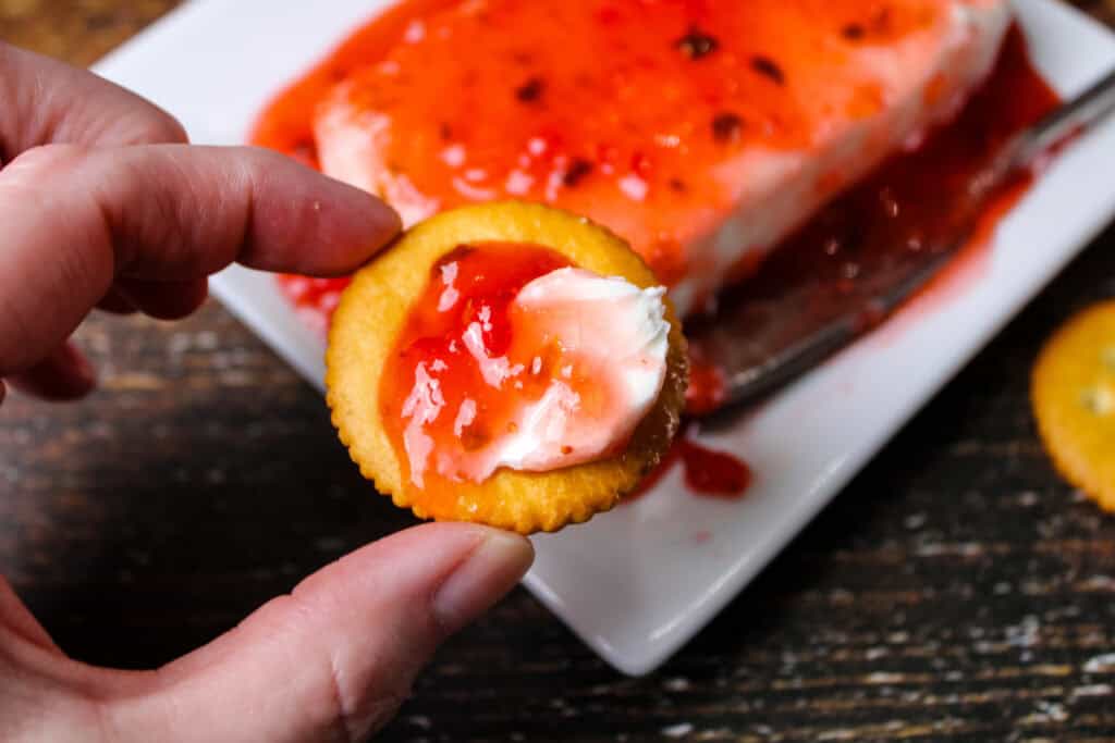 Strawberry jalapeno jam on a cracker with cream cheese 
