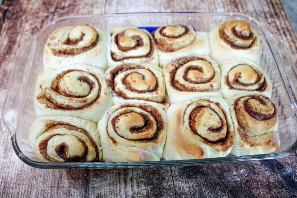 Machine cinnamon rolls fresh out of the oven before frosting is applied