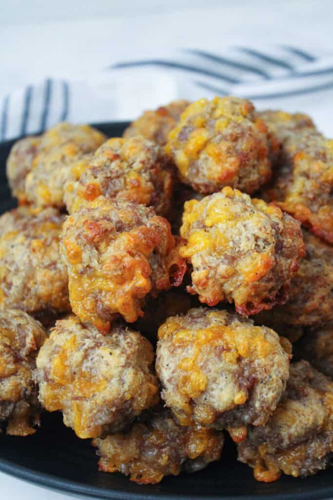 Close-up of homemade sausage balls showing melted cheddar cheese and tender sausage texture.