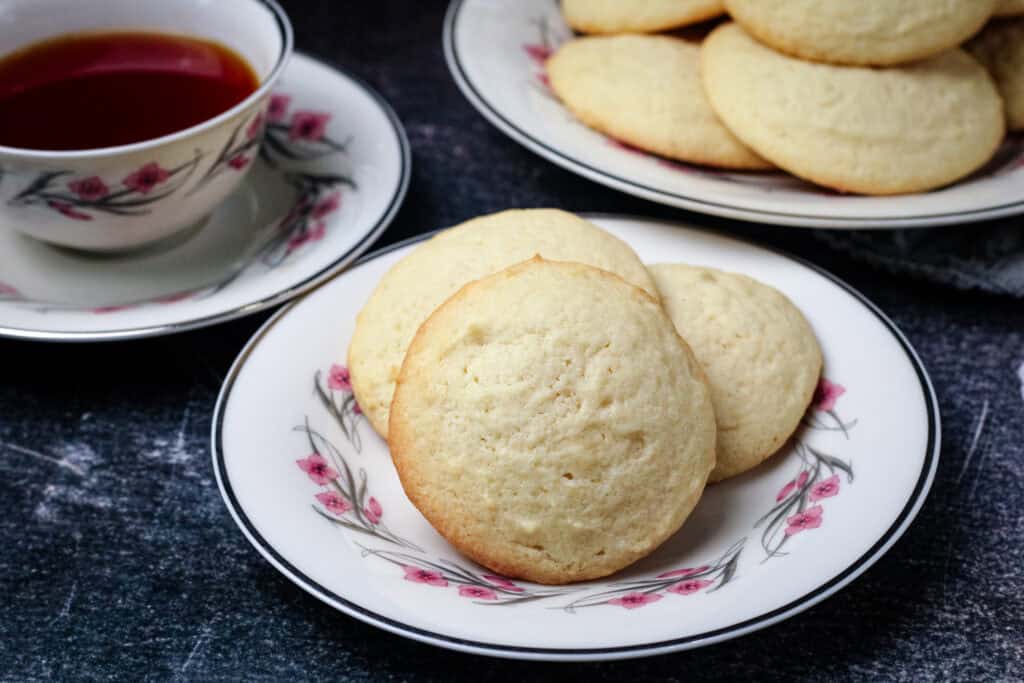 Old fashioned Southern Tea Cake cookies on a floral plate with hot tea