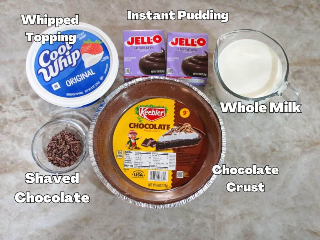 Ingredients for easy chocolate cream pie including instant chocolate pudding, whole milk, whipped topping, chocolate crust, and shaved chocolate