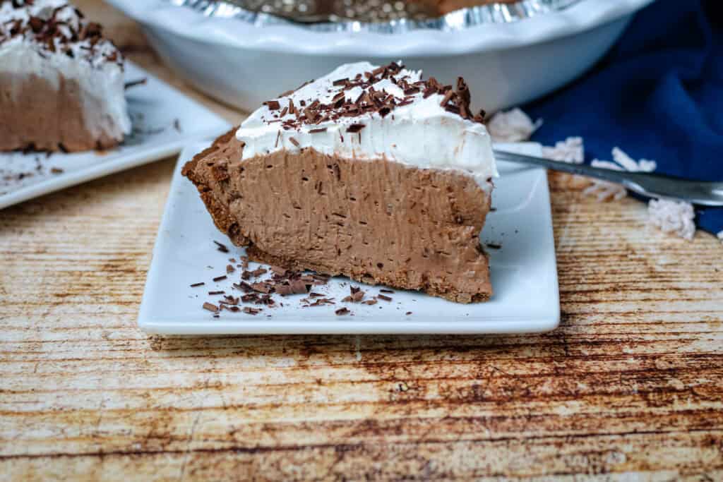 Slice of no bake chocolate cream pie showing thick creamy filling and chocolate crust