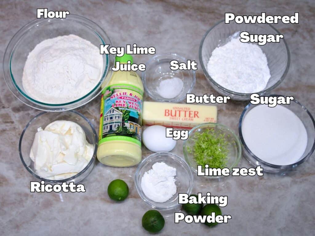 Ingredients for Key Lime Ricotta Cookies including flour, ricotta cheese, key lime juice, butter, egg, sugar, powdered sugar, lime zest, baking powder, and salt.